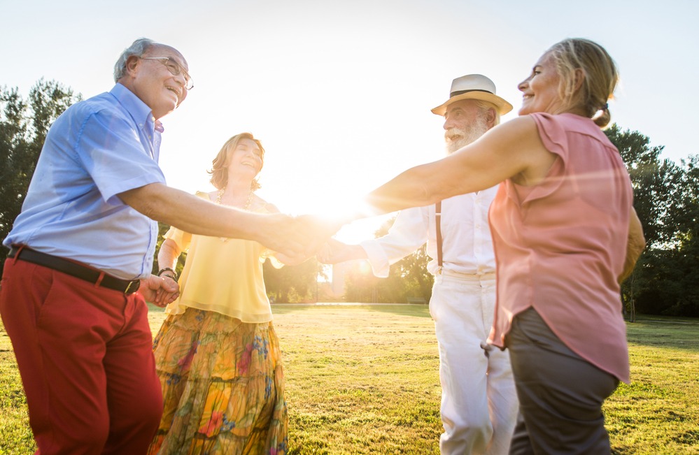 Eine Senioren-Gruppe freuend im Sonnenuntergang auf dem Golfplatz |  Wohrecht auf Lebenszeit - Rohde Immobilien Kleinmachnow